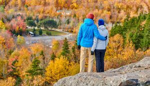 Couple hiking at Artist's Bluff in autumn - White Mountain National Forest, New Hampshire