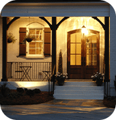Front door of house with light on at night